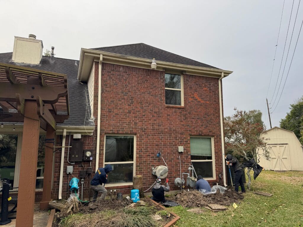The Deep Rock Foundations crew digs perimeter holes for concrete leveling slab foundation repair in Pearland, Texas