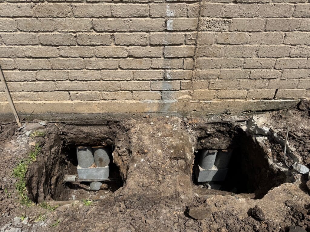 Perimeter pressed concrete pilings for foundation repair in Pearland, Texas