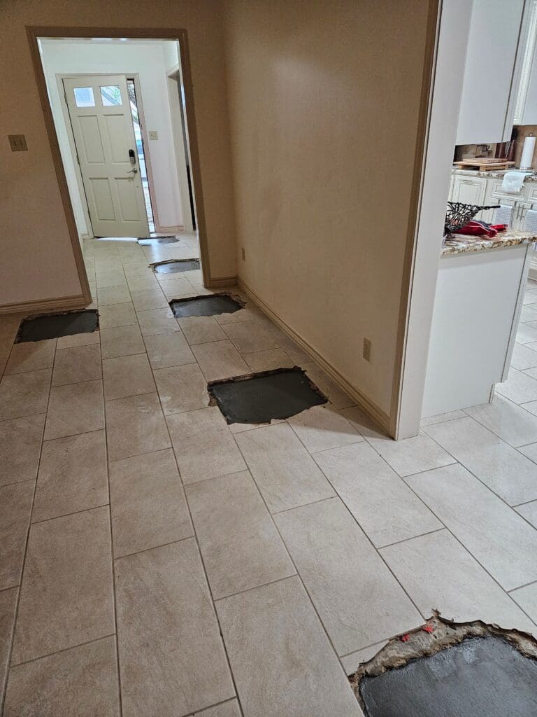 Interior holes are filled for concrete slab repair and leveling in Pearland, Texas