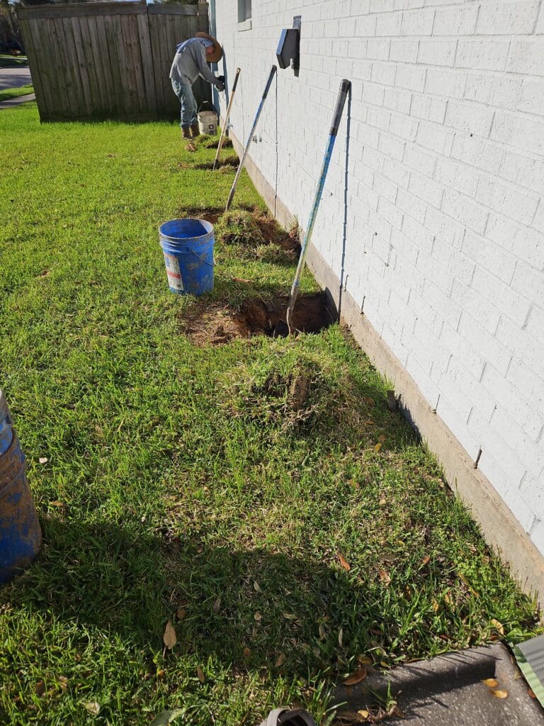Exterior piling holes completed by Pearland Foundation repair company