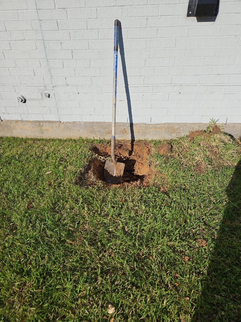 Digging is carefully done by hand to protect pipes and underground lines during best foundation repairs in Pearland